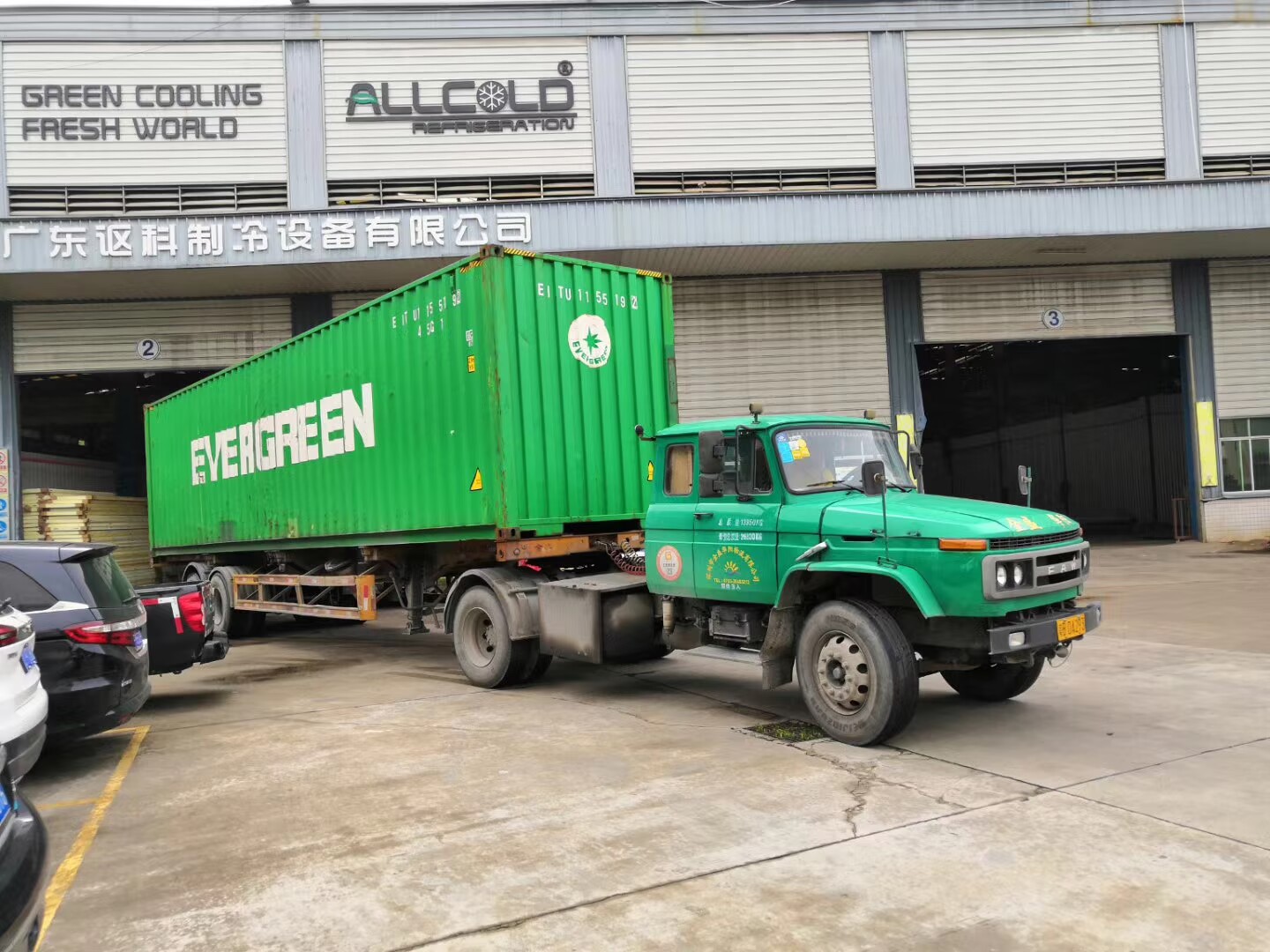Green container truck from Evergreen loading at ALLCOLD vacuum cooling equipment factory in Guangdong, China