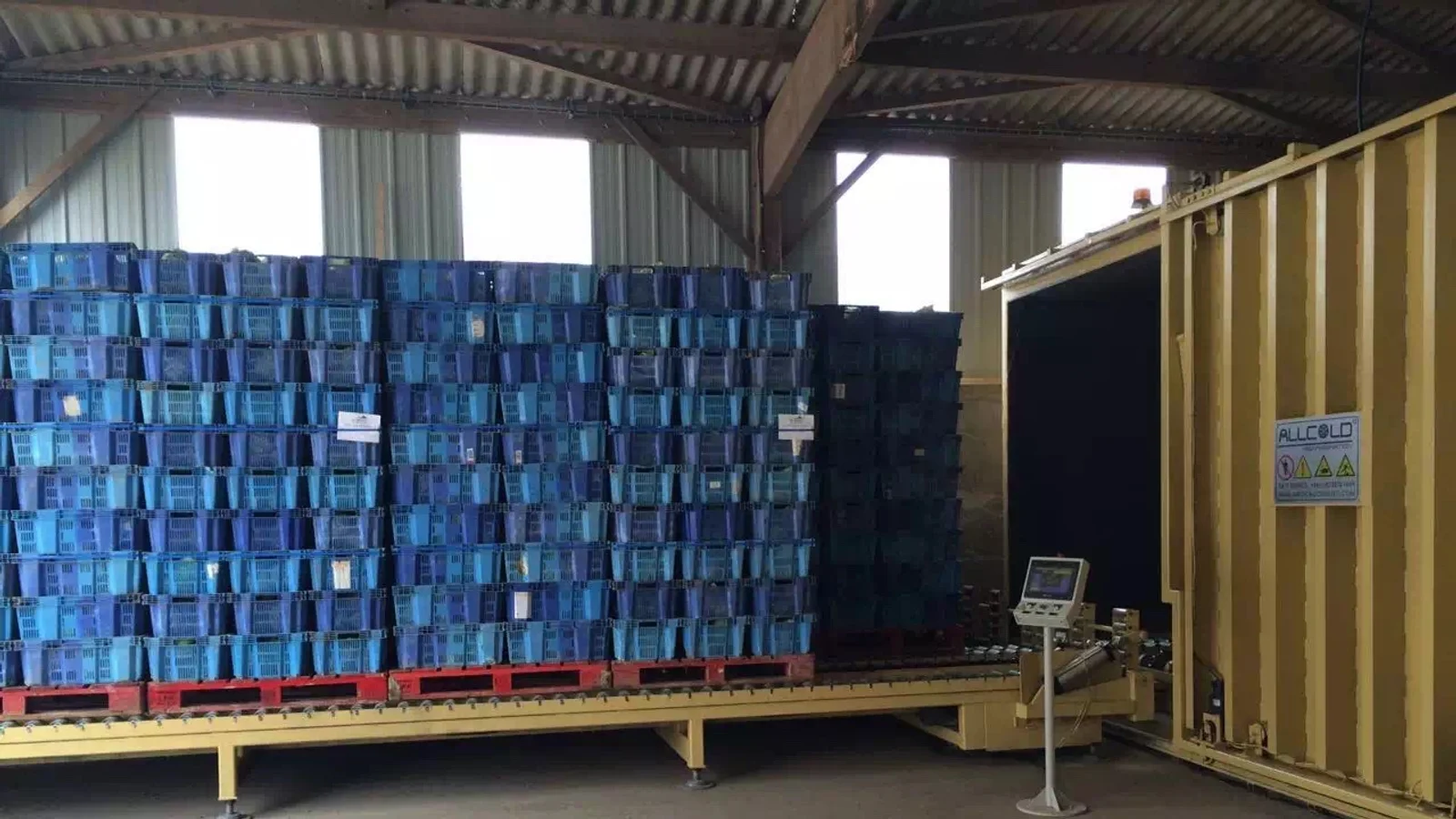 Commercial produce pallets positioned on an Allcold vacuum cooler loading platform