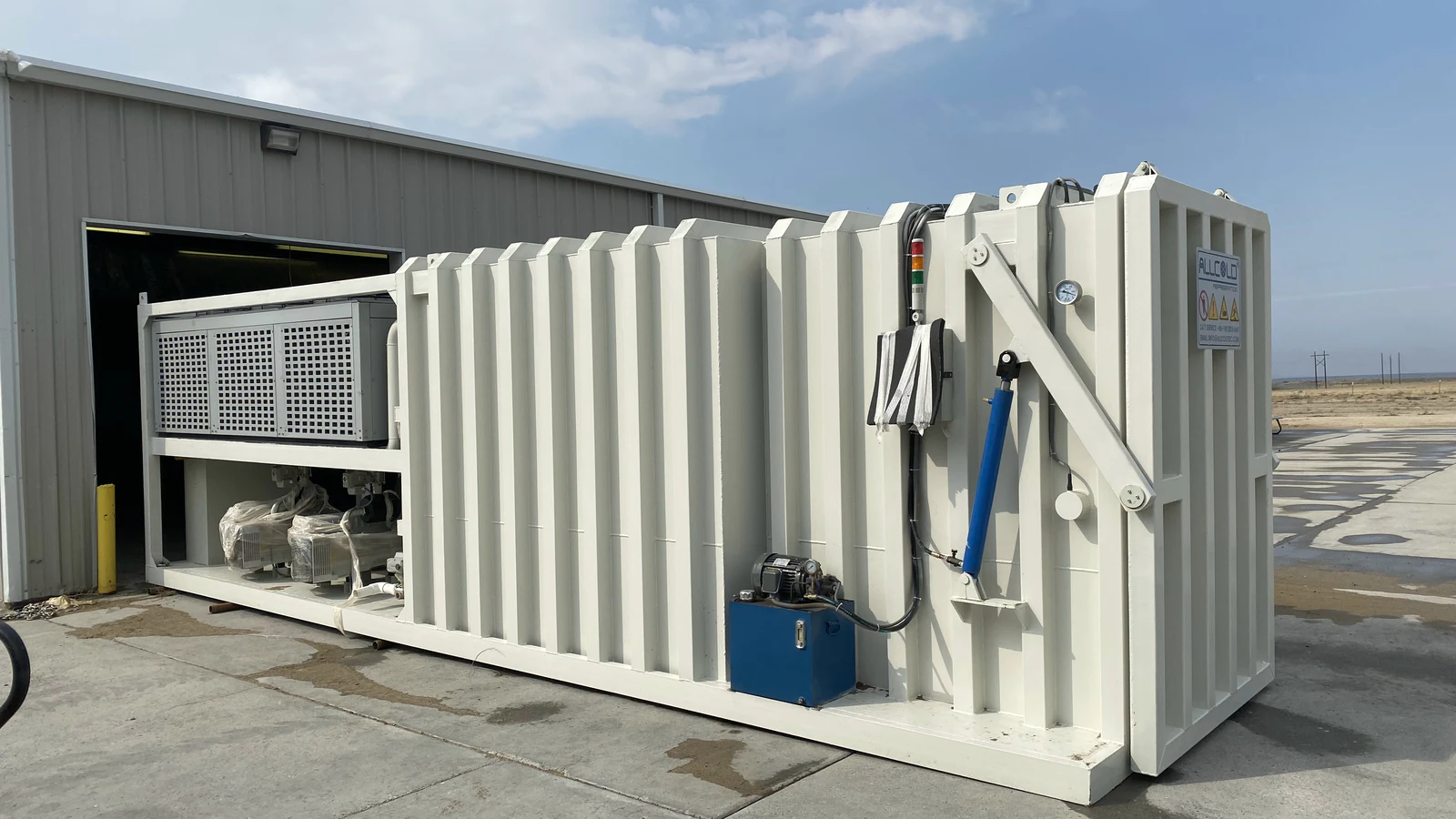 Complete Allcold vacuum cooler skid positioned outside a building