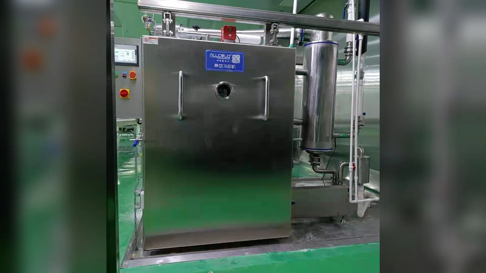 Real Allcold food vacuum cooler with visible water-cooled condenser and utility pipework