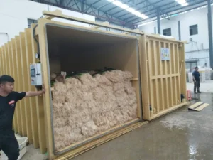 Bundled produce inside an Allcold yellow vacuum cooler with its horizontal sliding door open