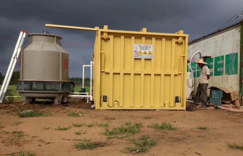 Historical Allcold site photograph showing a separate cooling tower beside a yellow vacuum-cooler chamber