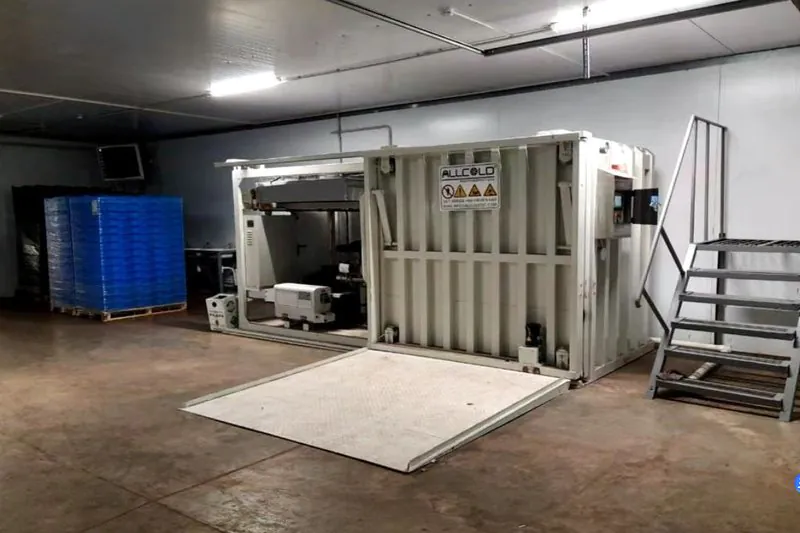 A small, compact, plug-and-play vacuum cooler sitting in a clean packing shed on a small farm.