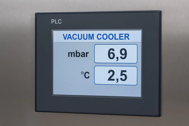 A close-up of a modern PLC touchscreen on a vacuum cooler, showing a clear digital readout of the pressure in millibars (mbar) and the corresponding temperature in Celsius.