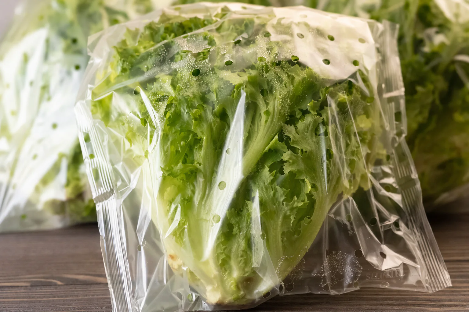 Compostable lettuce packaging with visible micro-perforations