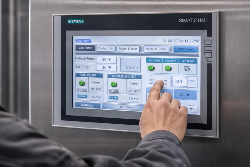 Operator interacting with the Siemens PLC touchscreen control panel
