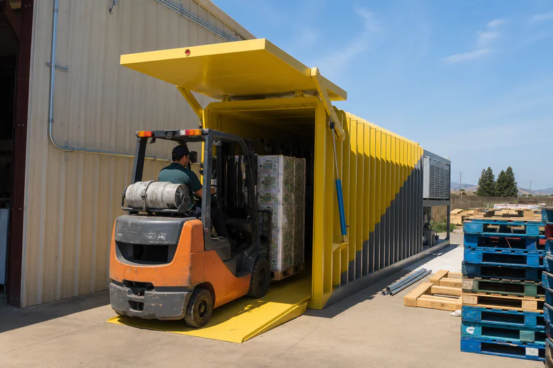 Forklift loading a wrapped pallet into a vacuum cooler chamber — showing correct vent alignment and pallet spacing inside the chamber